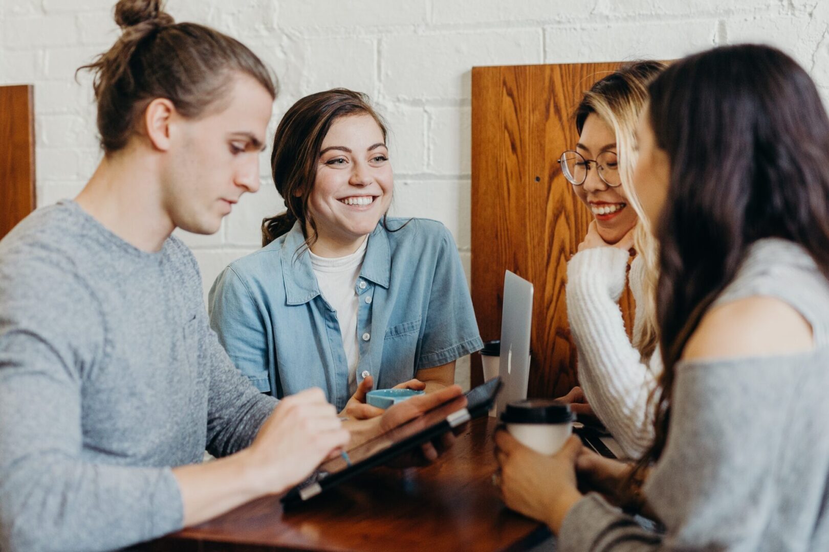 A Group of Women Talking by a Table